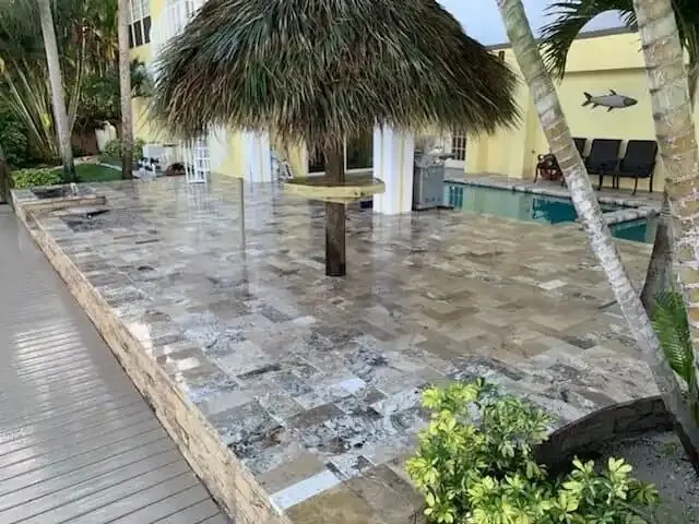 Backyard outdoor living area with tiki hut, pool and paver deck